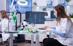 Female scientist typing on her computer the data from last scientific tests